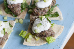 This April 28, 2014 photo shows grilled Middle Eastern lamb burgers with garlic sauce in Concord, N.H. Beef may claim to be whats for dinner in America, but in the Middle East that honor often goes to lamb. (AP Photo/Matthew Mead)