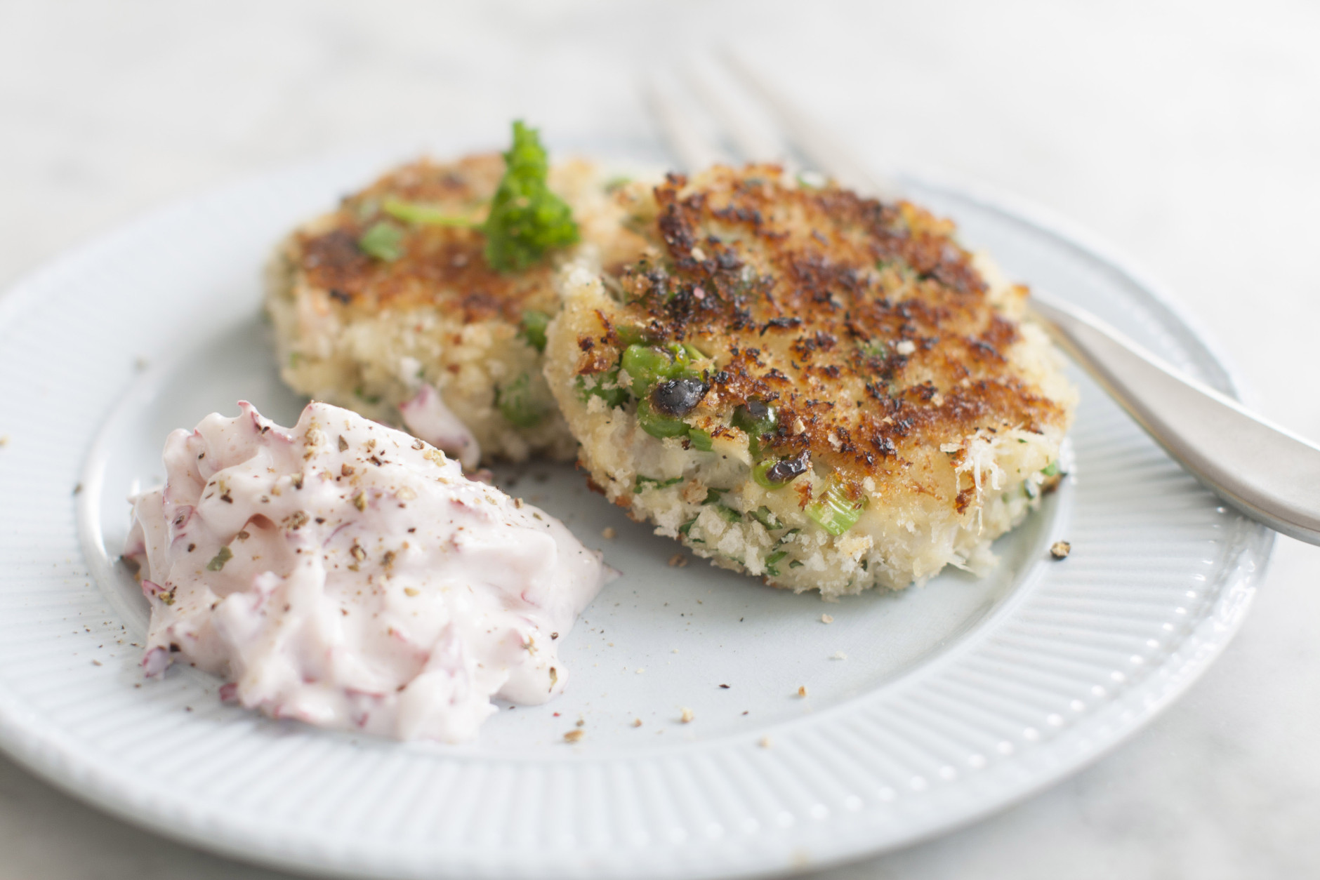 This Mar. 31, 2014 photo shows spring crab and shrimp cakes with double radish sauce in Concord, N.H. (AP Photo/Matthew Mead)
