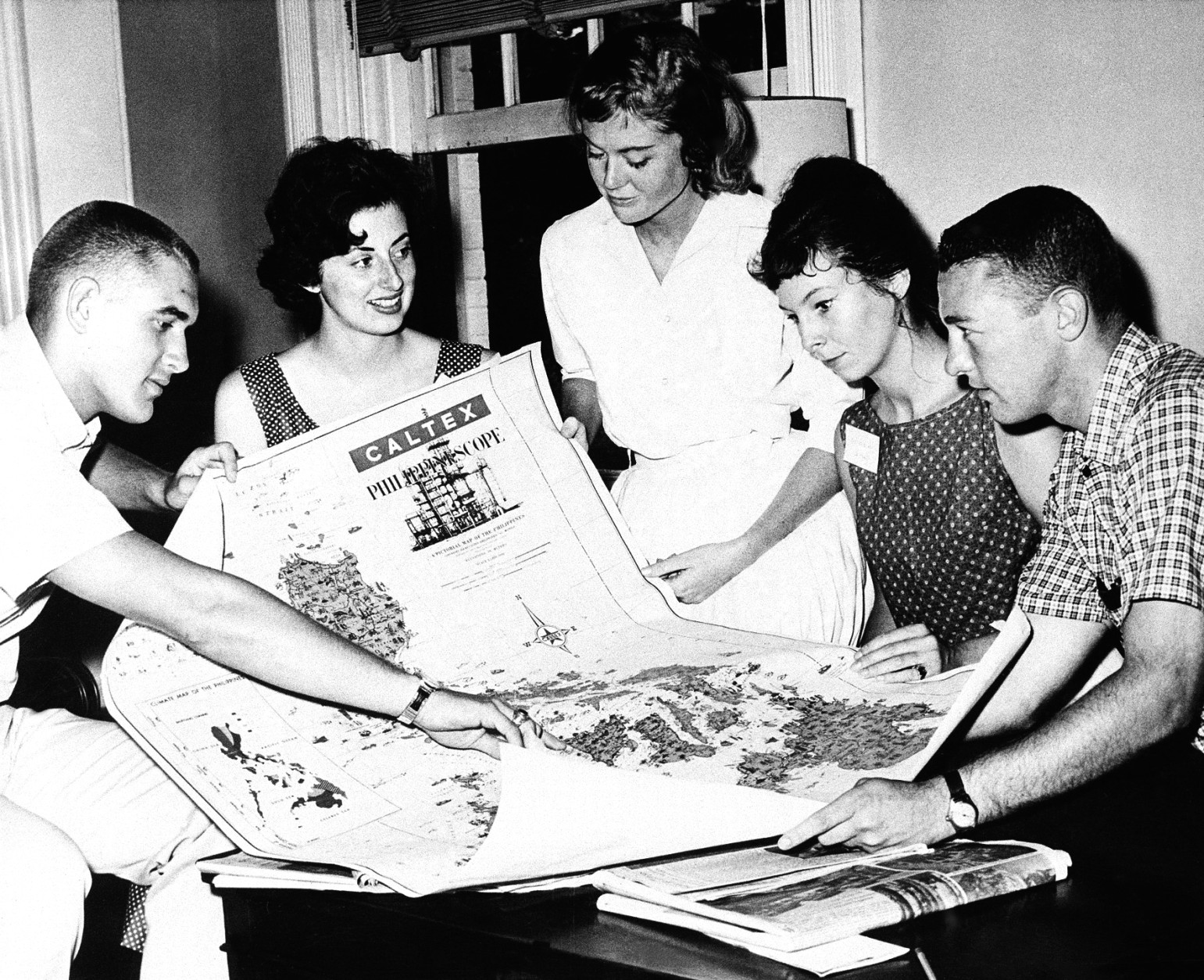 Five Peace Corps trainees, part of the 160 candidates that have reported at Pennsylvania State University for a seven-week training schedule, look at a map of the Philippine Islands in University Park, Pa. on July 31, 1961. The trainees will go there upon completion of training as teaching assistants in rural elementary schools. From left to right, Stuart Taylor, Berkeley, Calif.; Clair Ann Whiting, Cincinnati; Sandra Gay Williams, El Paso, Texas; Jenifer Grant, Armonik, N.Y.; David Pierson, Greenfield, Mass. (AP Photo/Paul Vathis)