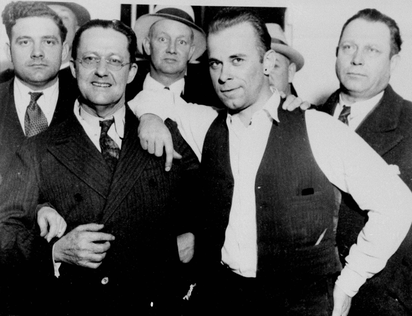 Captured desperado John Dillinger, wearing vest, strikes a jaunty pose with prosecutor Robert Estill in what would become an infamous image at the Crown Point, Ind., jailhouse, Feb. 1934. (AP Photo)
