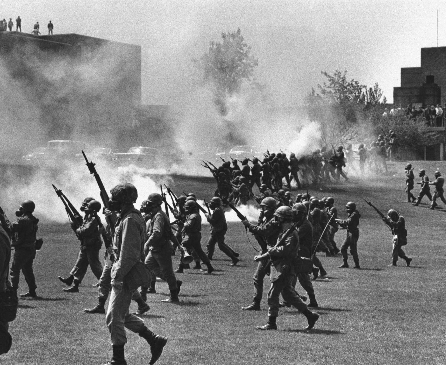 FILE - In a May 4, 1970 file photo, Ohio National Guard moves in on rioting students at Kent State University in Kent, Ohio. Four persons were killed and eleven wounded when National Guardsmen opened fire. The U.S. Justice Department, citing "insurmountable legal and evidentiary barriers," won't reopen its investigation into the deadly 1970 shootings by Ohio National Guardsmen during a Vietnam War protest at Kent State University. Assistant Attorney General Thomas Perez discussed the obstacles in a letter to Alan Canfora, a wounded student who requested that the investigation be reopened. The Justice Department said Tuesday, April 24, 2012 it would not comment beyond the letter.  (AP Photo, File)