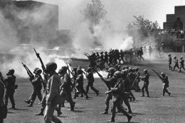 FILE - In a May 4, 1970 file photo, Ohio National Guard moves in on rioting students at Kent State University in Kent, Ohio. Four persons were killed and eleven wounded when National Guardsmen opened fire. The U.S. Justice Department, citing "insurmountable legal and evidentiary barriers," won't reopen its investigation into the deadly 1970 shootings by Ohio National Guardsmen during a Vietnam War protest at Kent State University. Assistant Attorney General Thomas Perez discussed the obstacles in a letter to Alan Canfora, a wounded student who requested that the investigation be reopened. The Justice Department said Tuesday, April 24, 2012 it would not comment beyond the letter.  (AP Photo, File)