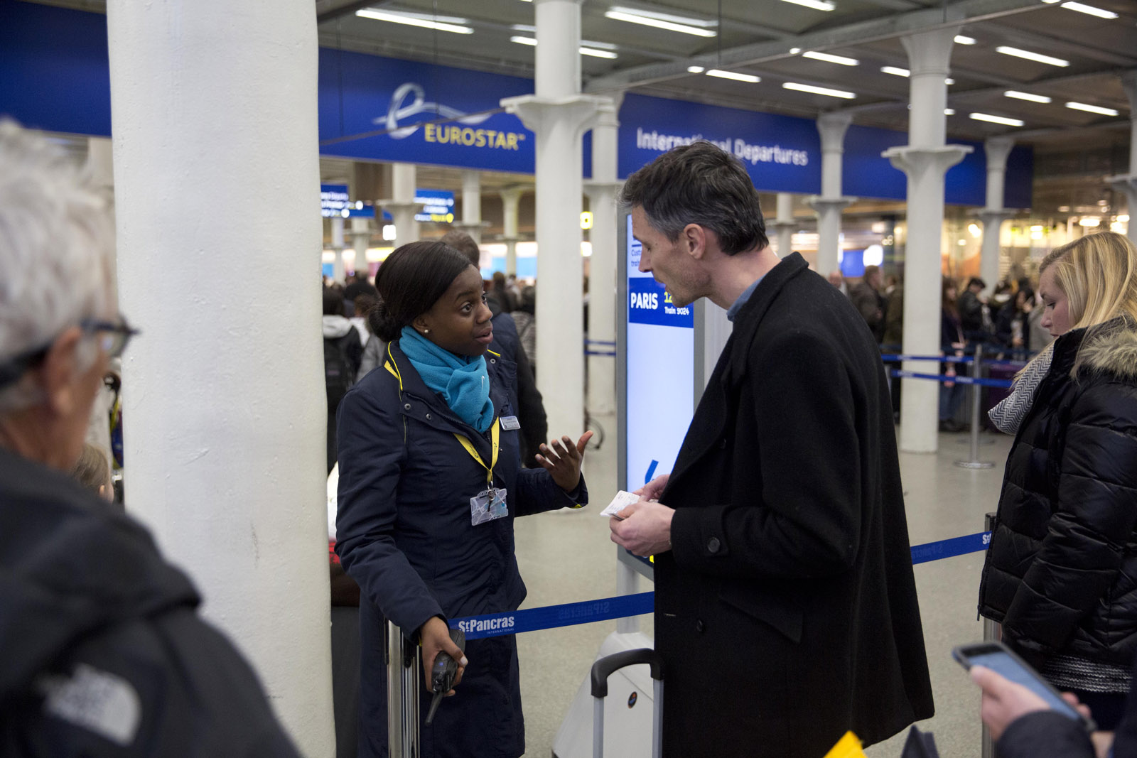 A Eurostar representative gives advice to a traveler after services were suspended on the Brussels Eurostar train route because of the attacks in Belgium, at St Pancras international railway station in London, Tuesday, March 22, 2016. Explosions, at least one likely caused by a suicide bomber, rocked the Brussels airport and subway system Tuesday, prompting a lockdown of the Belgian capital and heightened security across Europe. (AP Photo/Matt Dunham)