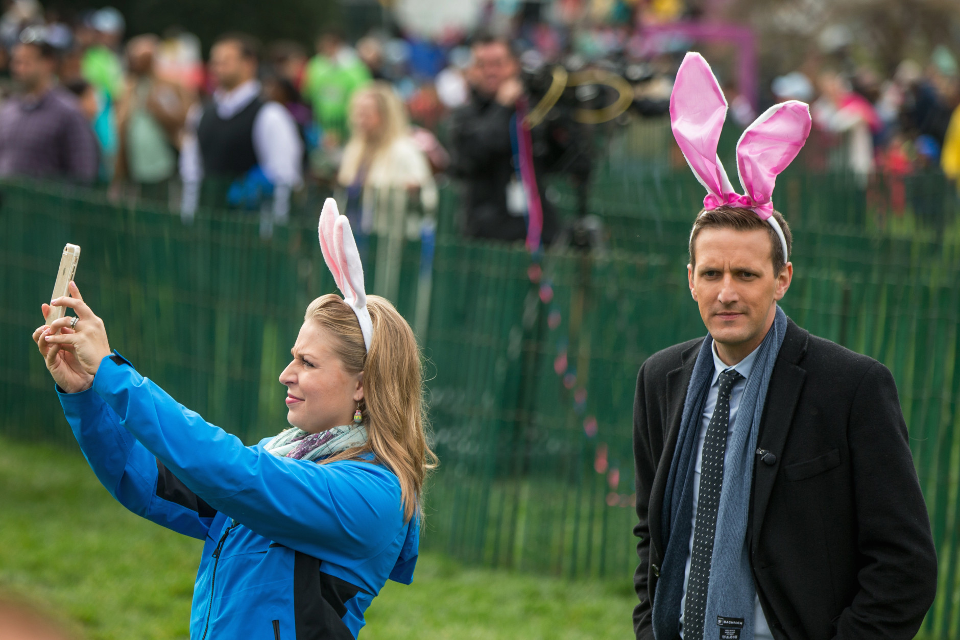 Two people wearing large bunny ears wait for President Barack Obama, first lady Michelle Obama and the Easter Bunny on the South Lawn of the White House in Washington, Monday, March 28, 2016, during the White House Easter Egg Roll. Thousands of children gathered at the White House for the annual Easter Egg Roll. This year's event features  live music, sports courts, cooking stations, storytelling, and Easter egg rolling. (AP Photo/Andrew Harnik)