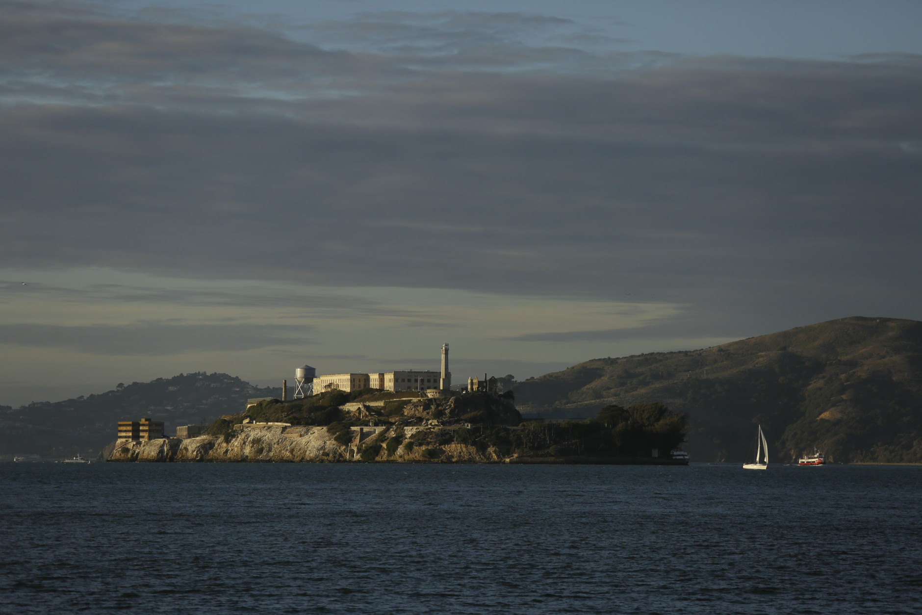 In this Nov. 5, 2015, photo, the sun sets on Alcatraz Island in San Francisco. The former federal prison of Alcatraz, once home to Al Capone, used to be a place people tried to escape; now it can be tough to get in. Book well in advance if you want to go; the Alcatraz Cruises ferries leave from Pier 33. (AP Photo/Eric Risberg)