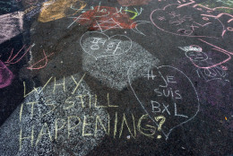 Solidarity messages are written in chalk outside the stock exchange in Brussels on Tuesday, March 22, 2016. Explosions, at least one likely caused by a suicide bomber, rocked the Brussels airport and subway system Tuesday, prompting a lockdown of the Belgian capital and heightened security across Europe. At least 26 people were reported dead. (AP Photo/Geert Vanden Wijngaert)