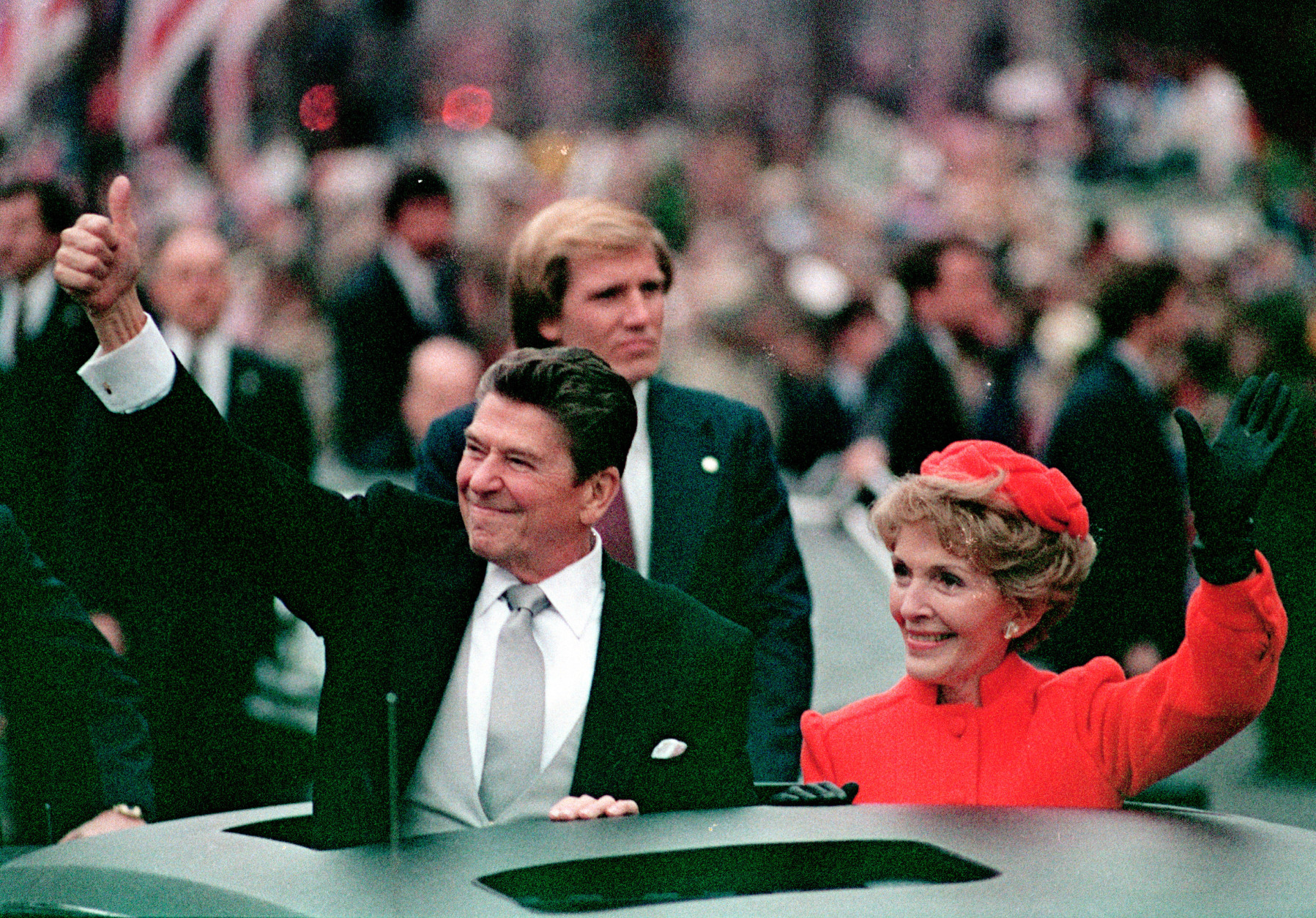FILE- This Jan. 20, 1981 file photo, shows President Ronald Reagan as he gives a thumbs up to the crowd while his wife, first lady Nancy Reagan, waves from a limousine during the inaugural parade in Washington following Reagan's swearing in as the 40th president of the United States. Sunday, Feb. 6, 2011, marks the centennial anniversary of Reagan's birth. (AP Photo/File)