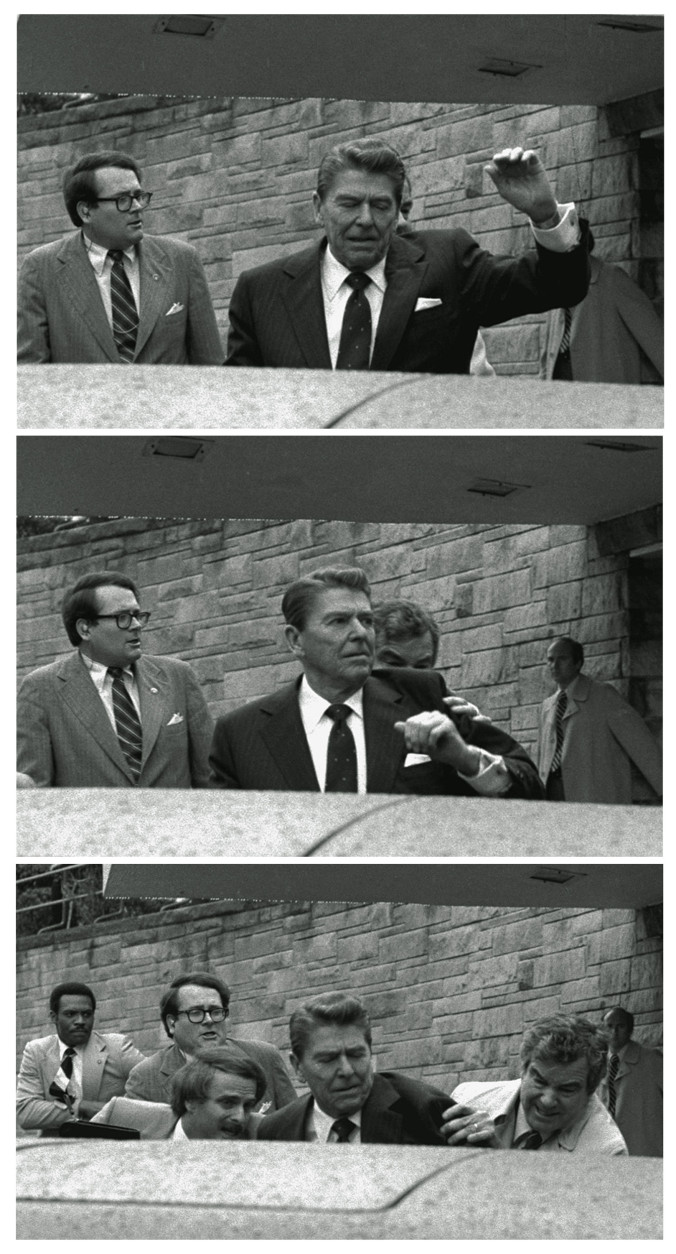 President Reagan waves, then looks up before being shoved into Presidential limousine by Secret Service agents after being shot outside a Washington hotel Monday, March 30, 1981. (AP Photo/Ron Edmonds)