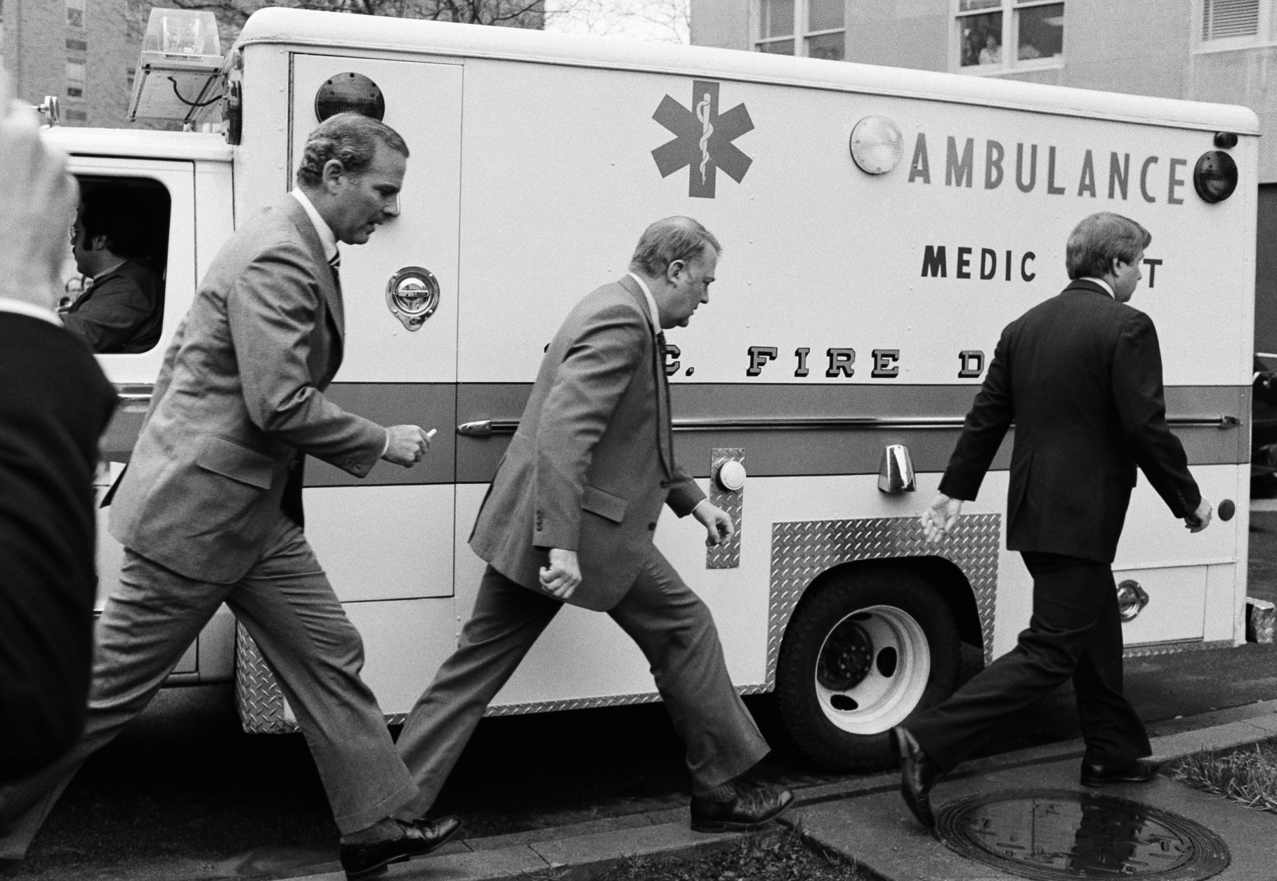 President assistants James Baker, left, Edwin Meese III and Larry Speakes arrive at George Washington University Hospital to see President Reagan in Washington on March 30, 1981. Reagan was shot as he left a Washington hotel. (AP Photo/Bob Daugherty)