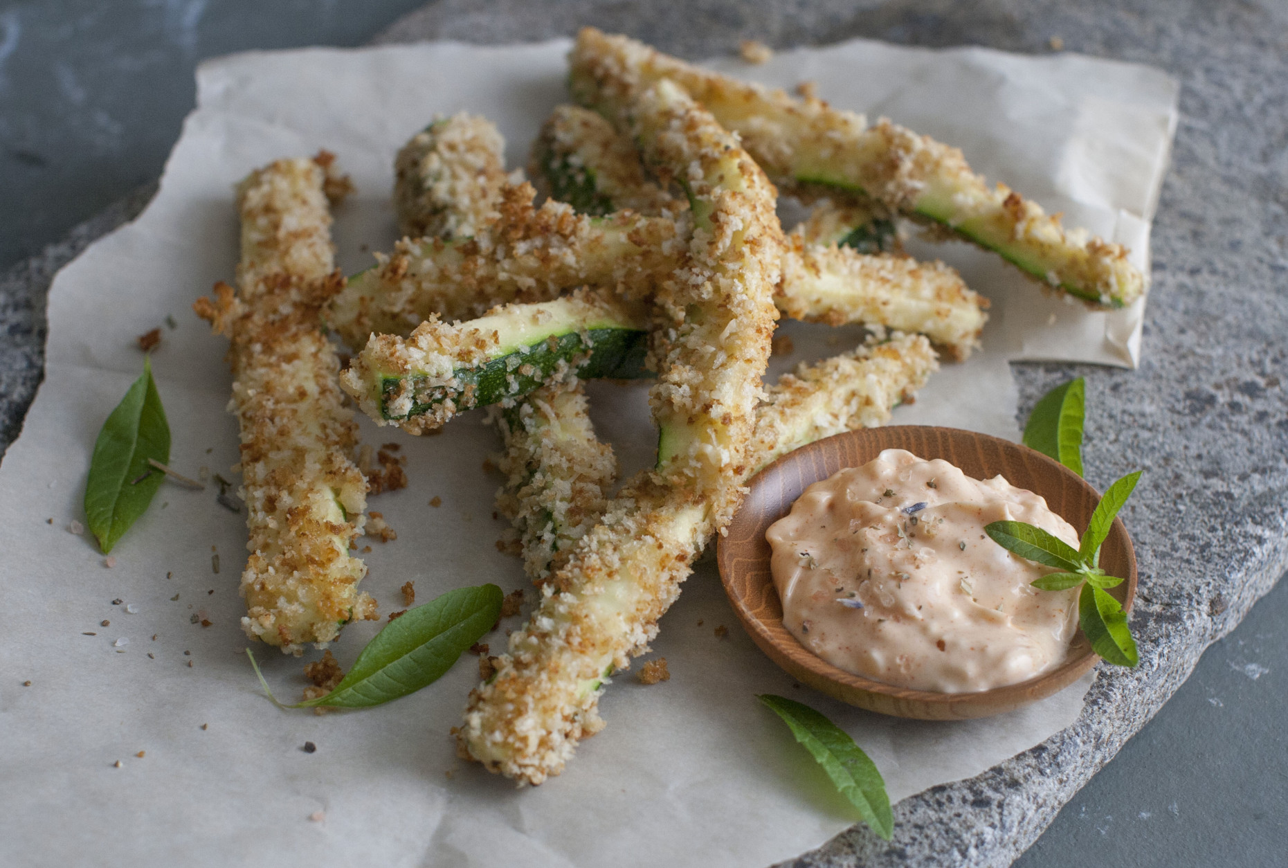 This June 30, 2014 photo shows cheesy zucchini fries with peprika dipping sauce in Concord, N.H. Cutting a zucchini into fry-like sticks, then cooking them delivers that signature crunch without the deep-frying. (AP Photo/Matthew Mead)