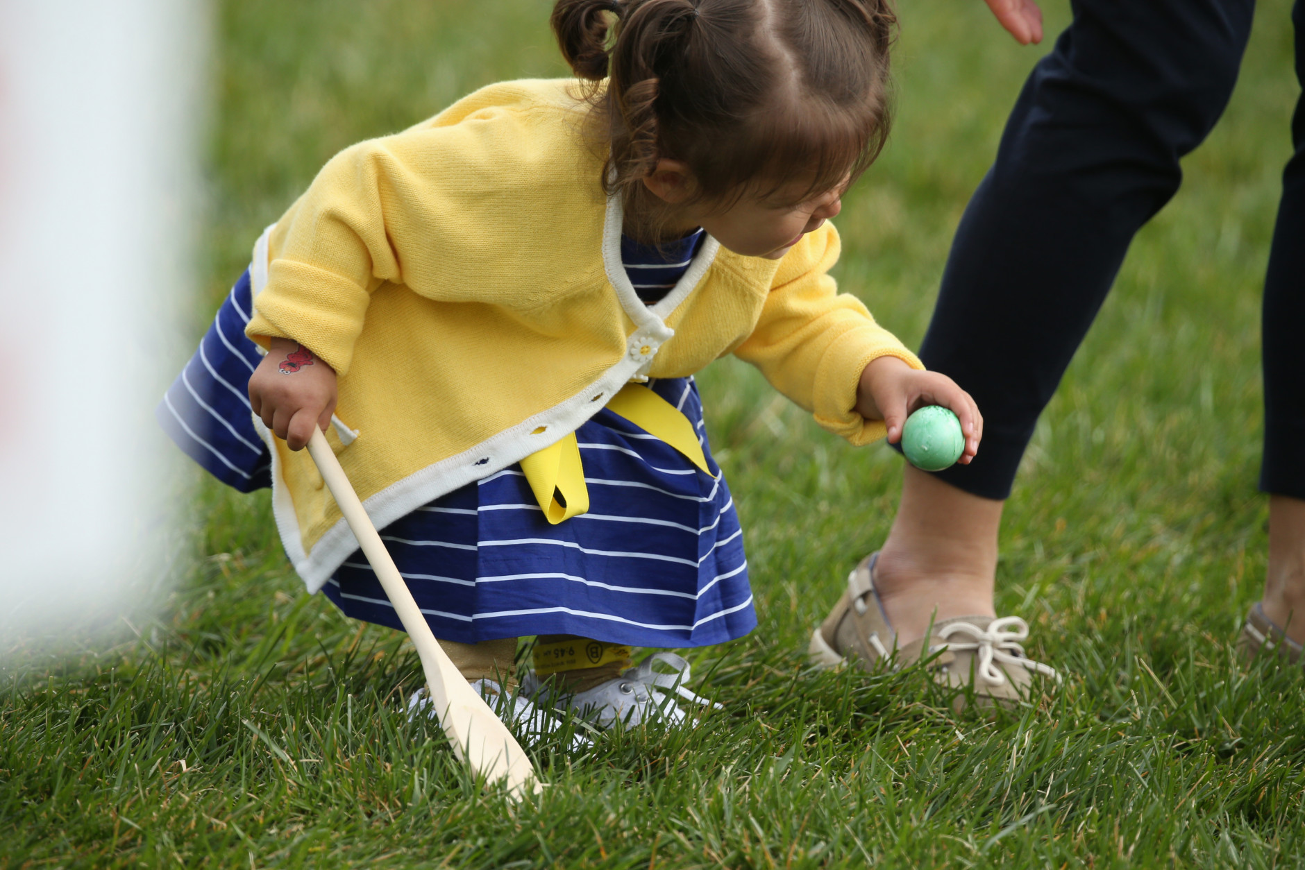 A child participates in the White House Easter Egg Roll on the South Lawn of the White House in Washington, Monday, March 28, 2016. Thousands of children gathered at the White House for the annual Easter Egg Roll. This year's event features  live music, sports courts, cooking stations, storytelling, and Easter egg rolling.