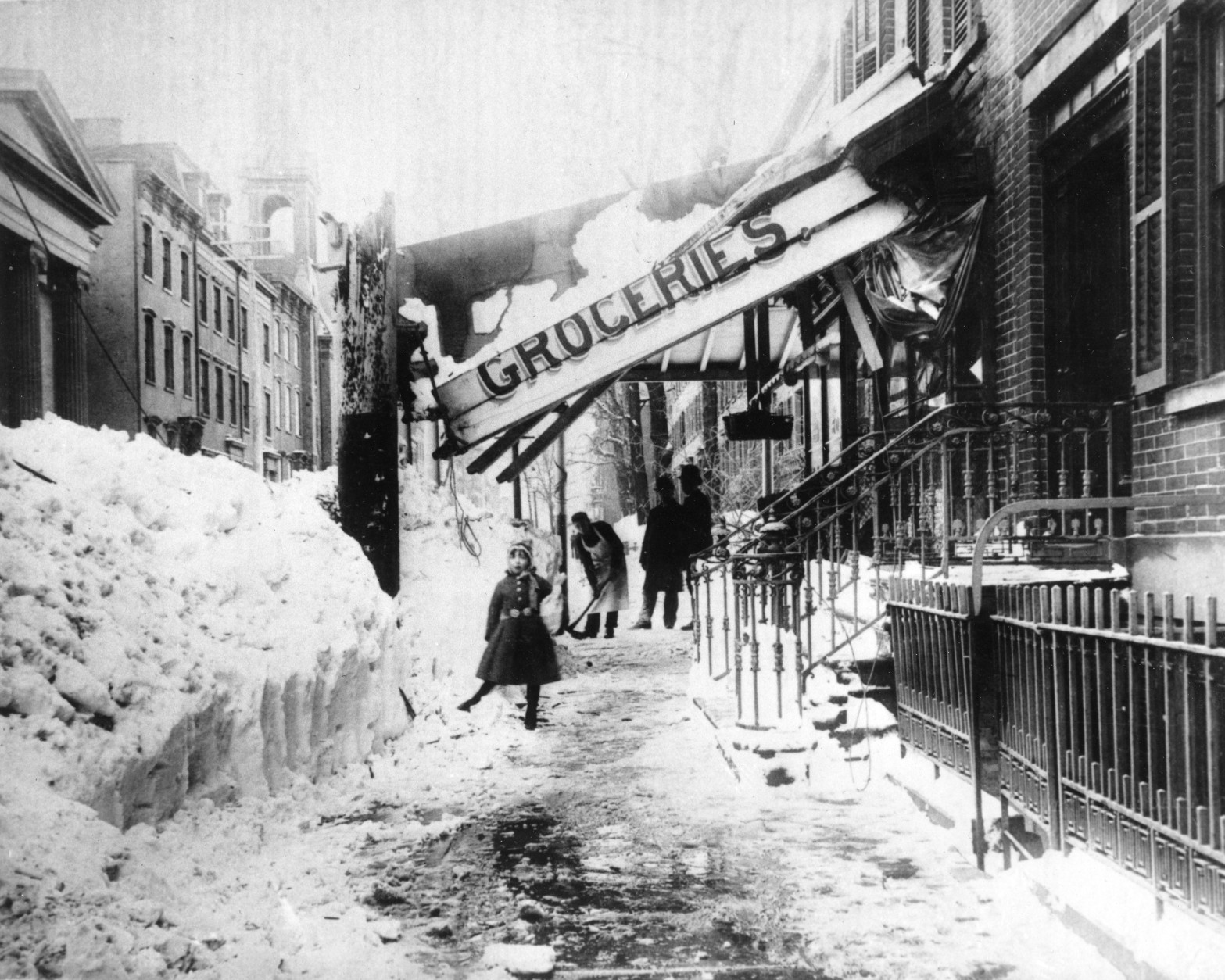 The awning of a grocery store is damaged from the weight of the snow during the blizzard of 1888 in New York City.  The blizzard on March 12-14 paralyzed the city with about 40" of snow and winds that reached up to 60 miles per hour, creating drifts as high as fifty feet.  (AP Photo)
