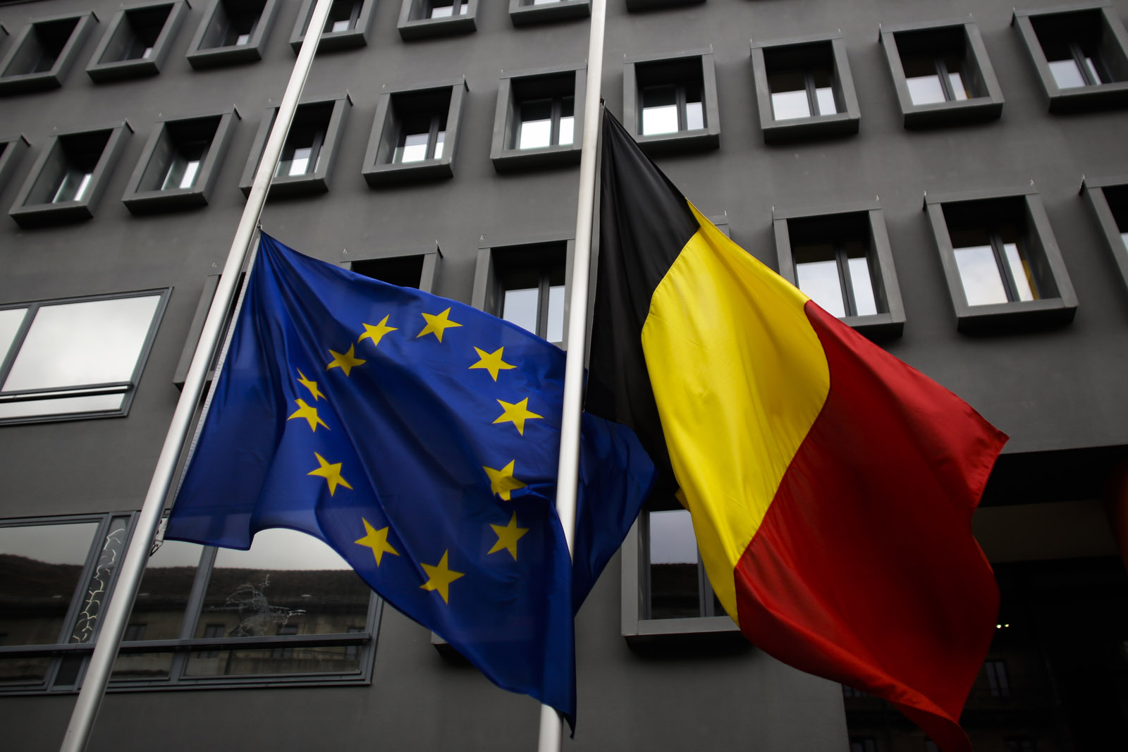 The European and the Belgian national flag set on half staff  after terrorist attacks in Brussels in front of the Belgium Embassy in Berlin, Germany, Tuesday, March 22, 2016. (AP Photo/Markus Schreiber)