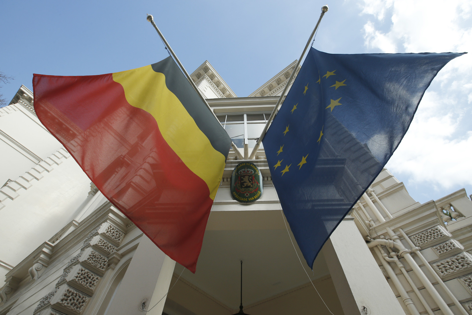 The Belgian Embassy in central  London, with the country's national flag and the flag of the European Union at half staff following the attacks in Brussels, Tuesday, March, 22, 2016. Authorities in Europe and beyond have tightened security at airports, on subways, at the borders and on city streets after deadly attacks Tuesday on the Brussels airport and its subway system. (AP Photo/Alastair Grant)