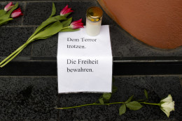 Flowers, a candle and a letter with the words 'Defy Terror' - ' Preserve Freedom' are  placed in front of the Belgian Embassy in Berlin, Germany, Tuesday, March 22, 2016 after the attacks in Brussels . Deadly attacks Tuesday at the Brussels airport and a metro station in the city are the latest in a string of attacks in Europe in recent years. (AP Photo/Markus Schreiber)