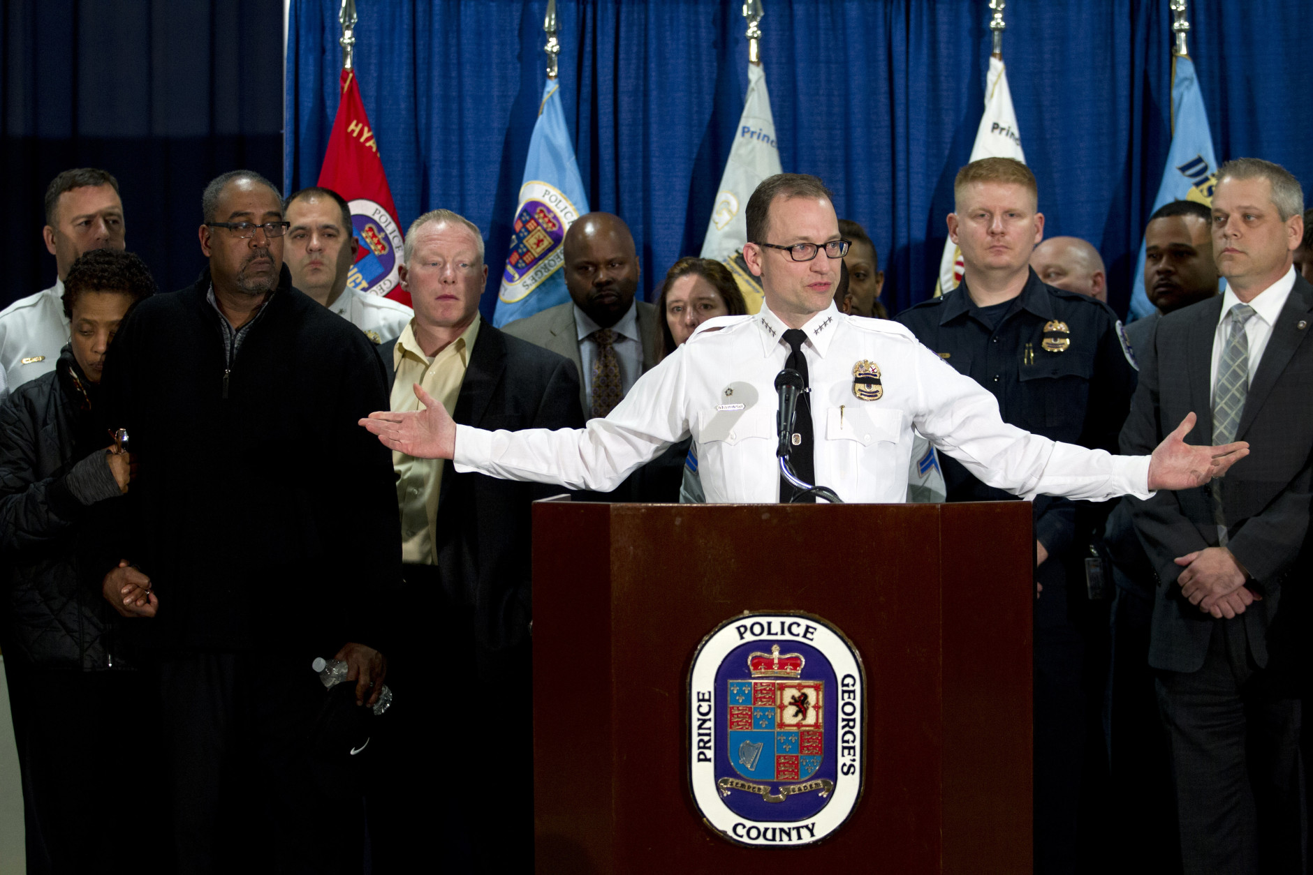Prince George's County police chief Hank Stawinski accompanied by the parents of police officer Jacai Colson, James and Sheila Colson speaks during a news conference at Prince George's County Police headquarters Monday, March 14, 2016, in Hyattsville, Md. Colson, a four-year veteran of the force was shot outside the District III police station. ( AP Photo/Jose Luis Magana)