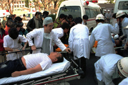 ** FILE ** Subway passengers are taken on stretchers from ambulances outside a Tokyo hospital after falling victim of the nerve gas attack by the Aum Shinrikyo cult on a subway on March 20, 1995 which killed 12 people and sickened more than 5,500 others. Japan's top court Friday, Sept. 15, 2006 rejected an appeal by the doomsday cult founder Shoko Asahara, a court official said, reportedly finalizing his death sentence for the 1995 nerve-gas attack. (AP Photo/Chiaki Tsukumo, File)