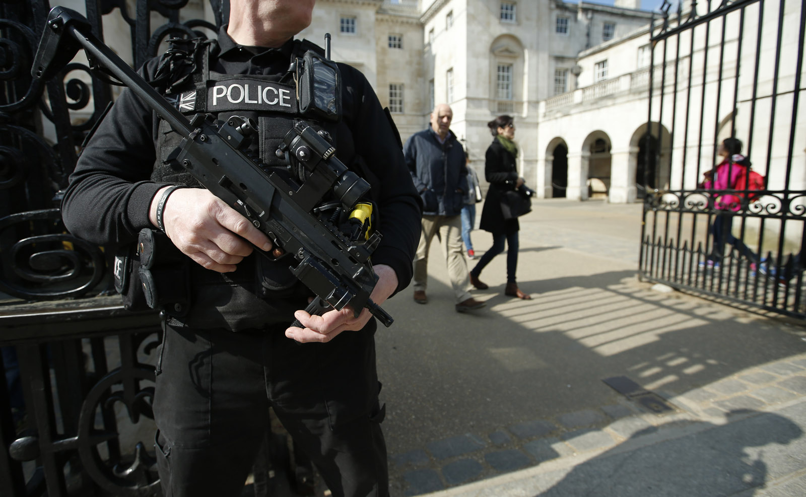 An armed British policeman stands on duty outside Horse Guards parade in central London, Tuesday, March 22, 2016. Authorities in Europe and beyond have tightened security at airports, on subways, at the borders and on city streets after deadly attacks Tuesday on the Brussels airport and its subway system. (AP Photo/Alastair Grant)