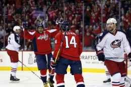 Washington Capitals left wing Alex Ovechkin (8), from Russia, and right wing Justin Williams (14) celebrate Williams' goal in the first period of an NHL hockey game against the Columbus Blue Jackets, Monday, March 28, 2016, in Washington. (AP Photo/Alex Brandon)