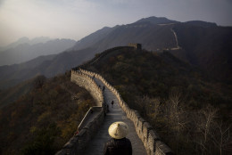 BEIJING, CHINA - OCTOBER 28: Chinese and foreign toursits walk on a section of the Great Wall of China on October 28, 2014 in Mutianyu, near Beijing, China.  (Photo by Kevin Frayer/Getty Images)