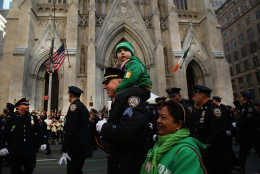 NEW YORK, NY - MARCH 17: Police officer Sgt. Slavin marches with his son in the annual St. Patrick's Day parade, one of the largest and oldest in the world on March 17, 2016 in New York City. Now that a ban on openly gay groups has been dropped, New York Mayor Bill de Blasio is attending the parade for the first time since he became mayor in 2014. The parade goes up Fifth Avenue ending at East 79th Street and will draw an estimated 2 million spectators along its 35-block stretch.  (Photo by Spencer Platt/Getty Images)