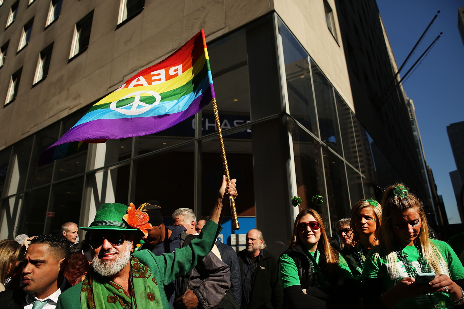 NEW YORK, NY - MARCH 17:  A man holds up a Gay Pride flag at the annual St. Patrick's Day parade, one of the largest and oldest in the world on March 17, 2016 in New York City. Now that a ban on openly gay groups has been dropped, New York Mayor Bill de Blasio is attending the parade for the first time since he became mayor in 2014. The parade goes up Fifth Avenue ending at East 79th Street and will draw an estimated 2 million spectators along its 35-block stretch.  (Photo by Spencer Platt/Getty Images)