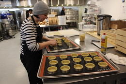A Union Kitchen member prepares tiny pastry tins in the communal kitchen. (WTOP/Dana Gooley) 