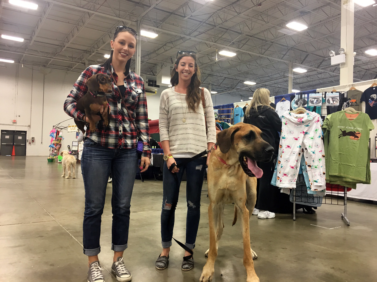 Valerie Warriner (left), from Herndon, with one of her two Dachshunds and Kelsey Scott (right), from Haymarket, and her Great Dane, Dakota. (WTOP/Mike Murillo)