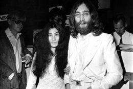 Beatle John Lennon and his wife, Yoko Ono, left, are shown in June 1969 at an airport at an unknown location.  (AP Photo)