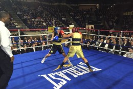 Katherine Kinnear (in blue gloves) and Michelle Soto fight in the Naval Academy's annual Brigade Boxing Championship. (WTOP/Michelle Basch)