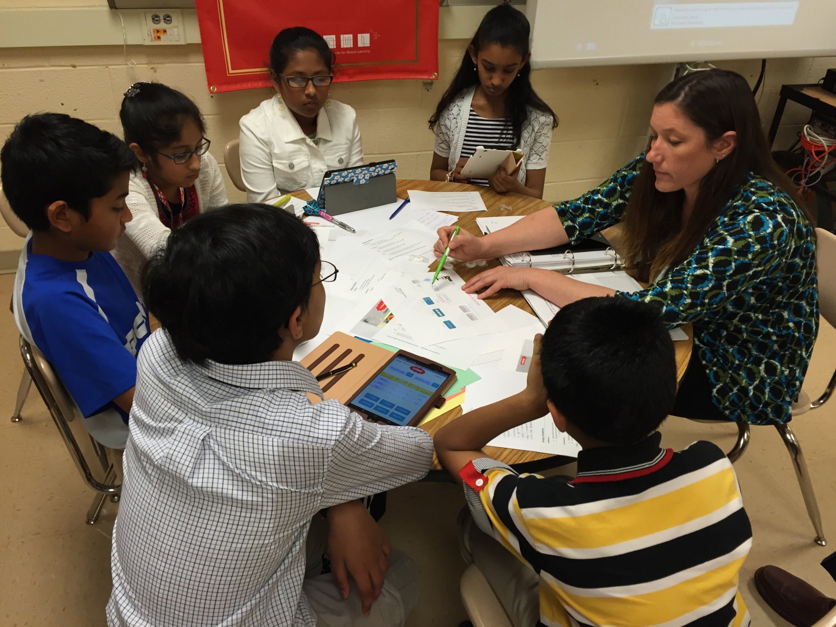 Kristin Violette, a member of the MIT App Inventor Master Trainers, is helping six Montgomery County middle school students turn their award-winning app concept into a working, mobile app.  (WTOP/Michelle Basch)