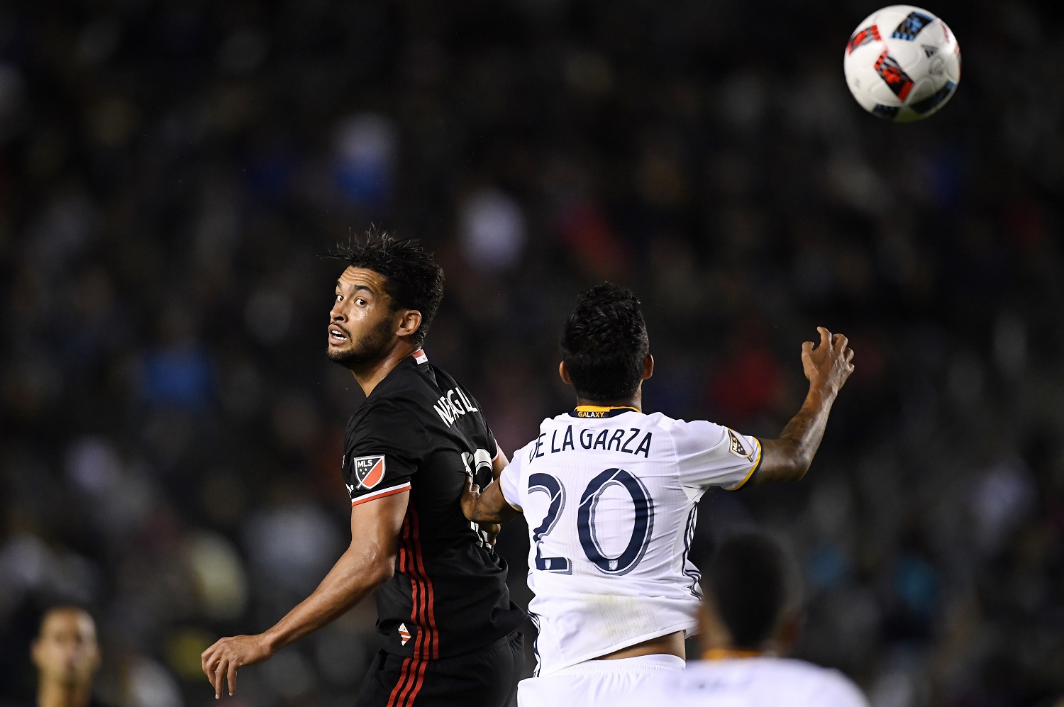 D.C. United midfielder Lamar Neagle, left, and Los Angeles Galaxy defender A. J. DeLaGarza try to head the ball during the first half of an Major League Soccer match, Sunday, March 6, 2016, in Carson, Calif. (AP Photo/Mark J. Terrill)
