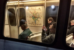 A normal commute -- putting on makeup on Metro. (WTOP/Neal Augenstein)