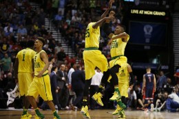 Oregon guard Kendall Small, right, and forward Chris Boucher (25) jump into the air in celebration during the first half of an NCAA college basketball game against Arizona in the semifinal round of the Pac-12 men's tournament Friday, March 11, 2016, in Las Vegas. (AP Photo/John Locher)