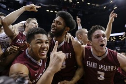 Saint Joseph's players celebrate after beating  VCU 87-74 in the championship NCAA basketball game of the Atlantic 10 men's tournament, Sunday, March 13, 2016, in New York. (AP Photo/Julie Jacobson)