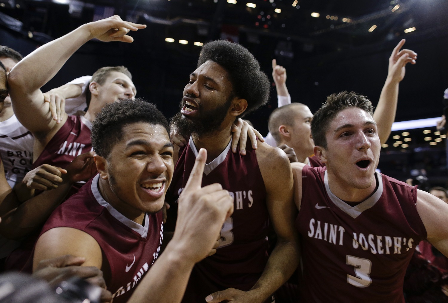 Saint Joseph's players celebrate after beating  VCU 87-74 in the championship NCAA basketball game of the Atlantic 10 men's tournament, Sunday, March 13, 2016, in New York. (AP Photo/Julie Jacobson)