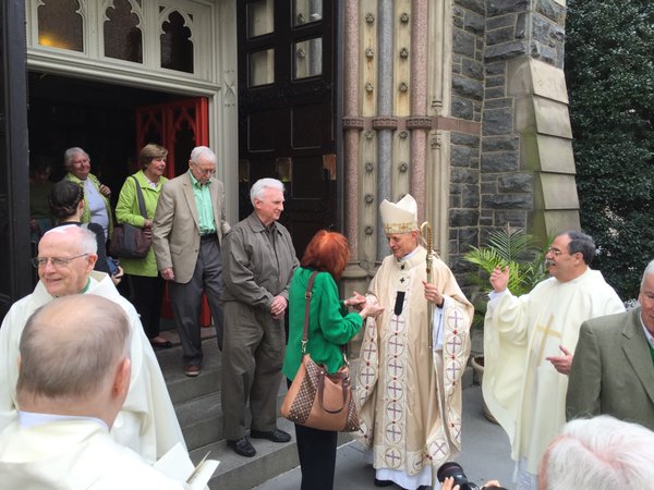 "Go in peace." Clergy speaks with the departing faithful at St. Patrick Church in D.C. (WTOP/Kristi King)