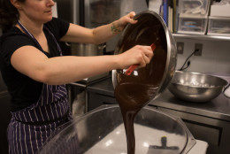 Photo of Jennifer Costa pouring chocolate into a large egg mold