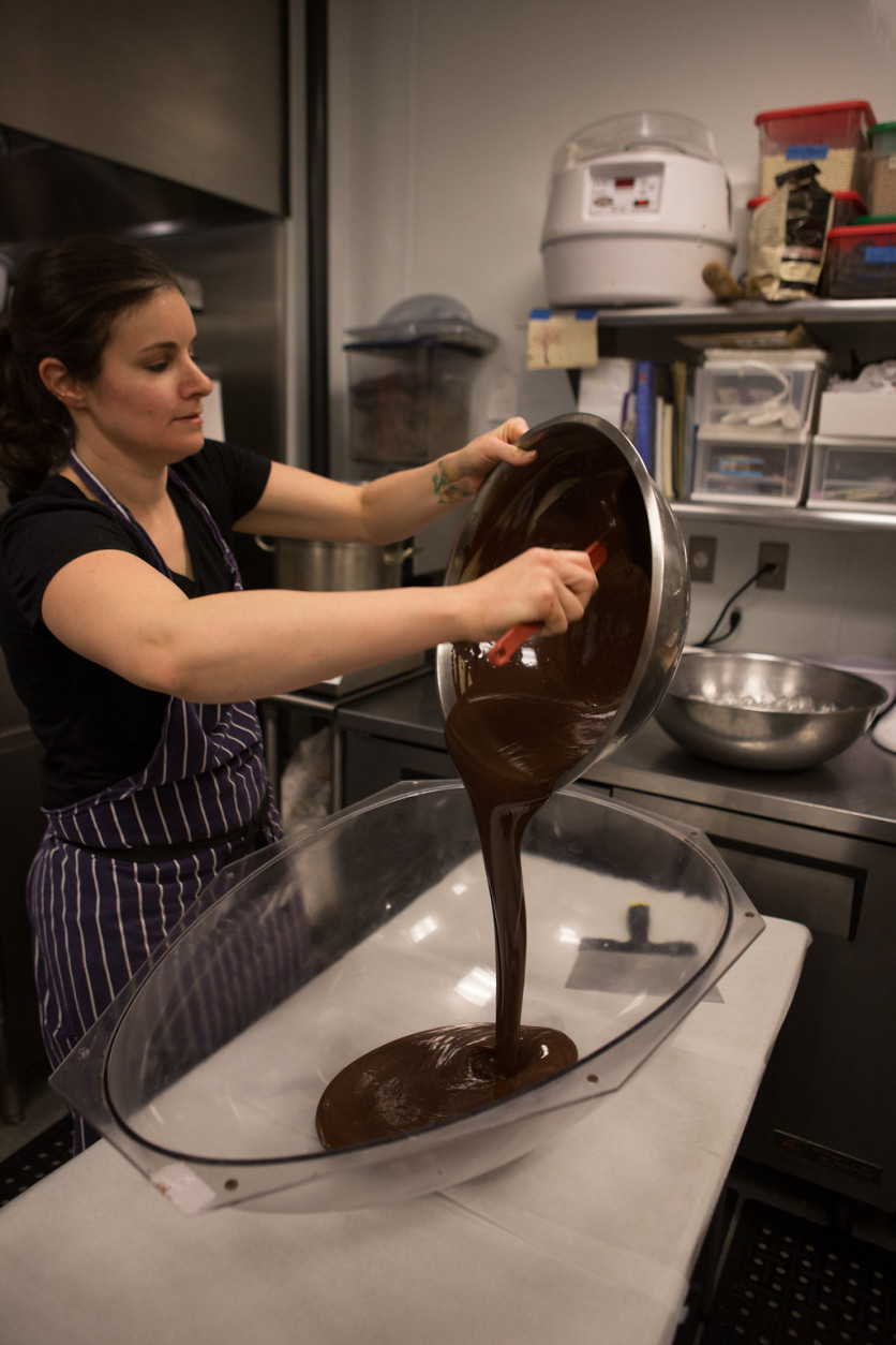 Photo of Jennifer Costa pouring chocolate into a large egg mold