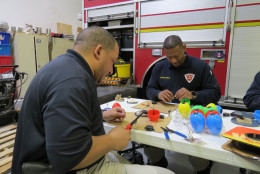 Bomb Squad techs with the Prince George's County Fire Department work to create "beeping eggs" for visually impaired children. (Courtesy Teresa Ann Crisman, PGFD)