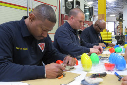 Bomb Squad techs with the Prince George's County Fire Department work to create "beeping eggs" for visually impaired children. (Courtesy Teresa Ann Crisman, PGFD)