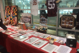 Silent auction at Saturday's Guns and Hoses benefit. (WTOP/Meg Hasken)