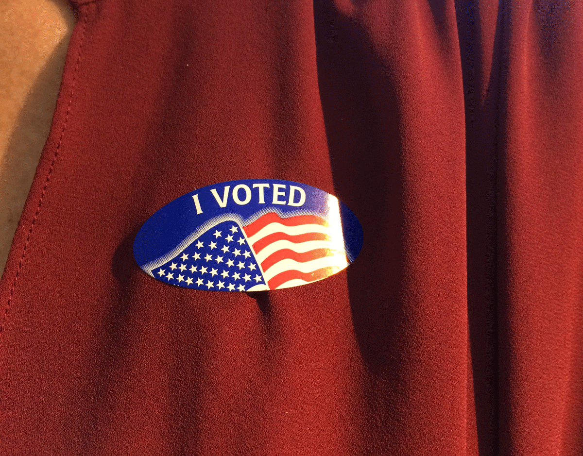 A WTOP staffer shows off an "I Voted" sticker on Tuesday. (WTOP/Sarah Beth Hensley)