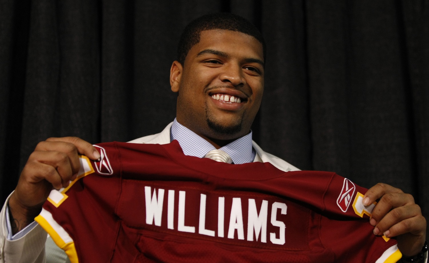 Washington Redskins first-round draft pick Trent Williams holds up a jersey during an NFL football news conference at Redskins Park, Friday, April 23, 2010, in Ashburn, Va.(AP Photo/Luis M. Alvarez)