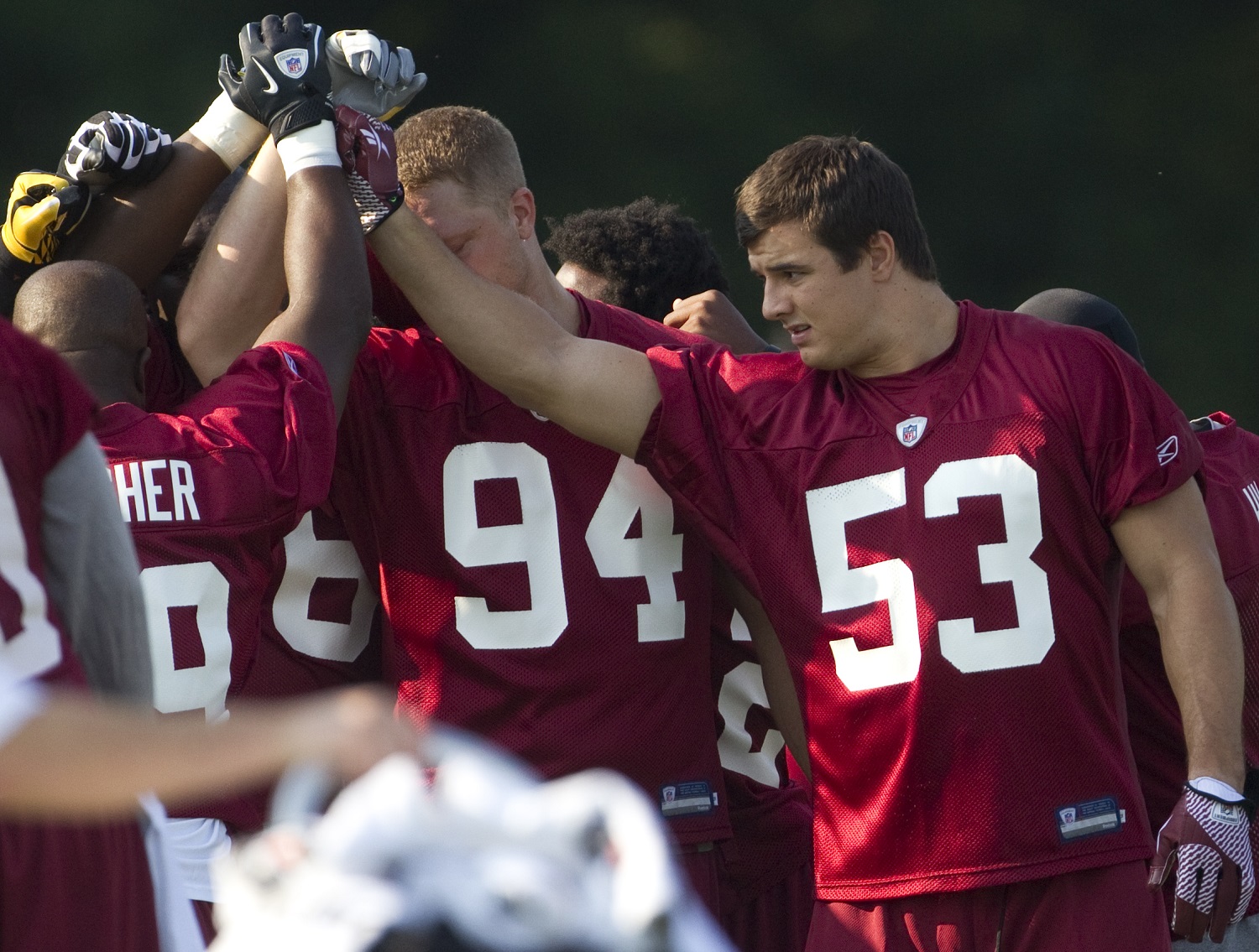 Washington Redskins first round draft pick Ryan Kerrigan (53) gets in a huddle during the NFL football team's training camp practice on Friday, July 29, 2011, in Ashburn, Va.  (AP Photo/Evan Vucci)
