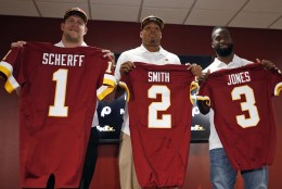 Washington Redskins NFL football draft picks, from left, offensive lineman Brandon Scherff, linebacker Preston Smith, and running back Matt Jones, hold up jerseys for a photograph during a media availability Saturday, May 2, 2015, in Landover, Md. (AP Photo/Alex Brandon)