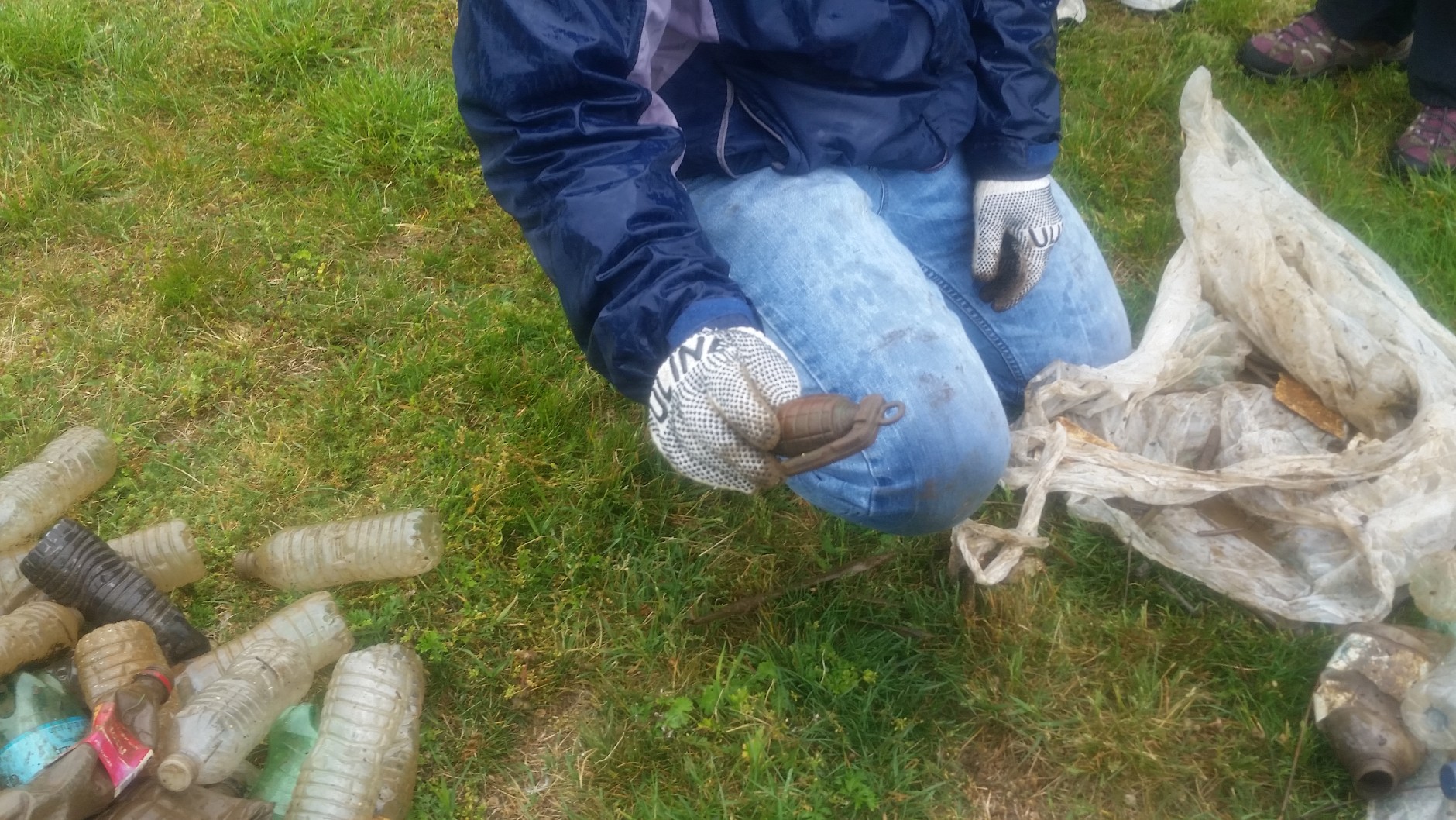  Matt Robinson from D.C.'s Department of Energy and the Environment found what apperas to be a plastic grenade during an Earth Day cleanup at Anacostia's River Terrace Park. (WTOP/Allison Keyes)