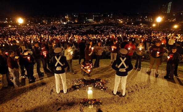 BLACKSBURG, VA - APRIL 16:  Corps of Cadets guards keep watch next to a ceremonial candle during a candlelight vigil on Virginia Tech's Day of Remembrance honoring the 32 people killed by Cho Seung-Hui April 16, 2008 in Blacksburg, Virginia.  Today is the one-year anniversary of the worst school shooting in US history.  (Photo by Mario Tama/Getty Images)