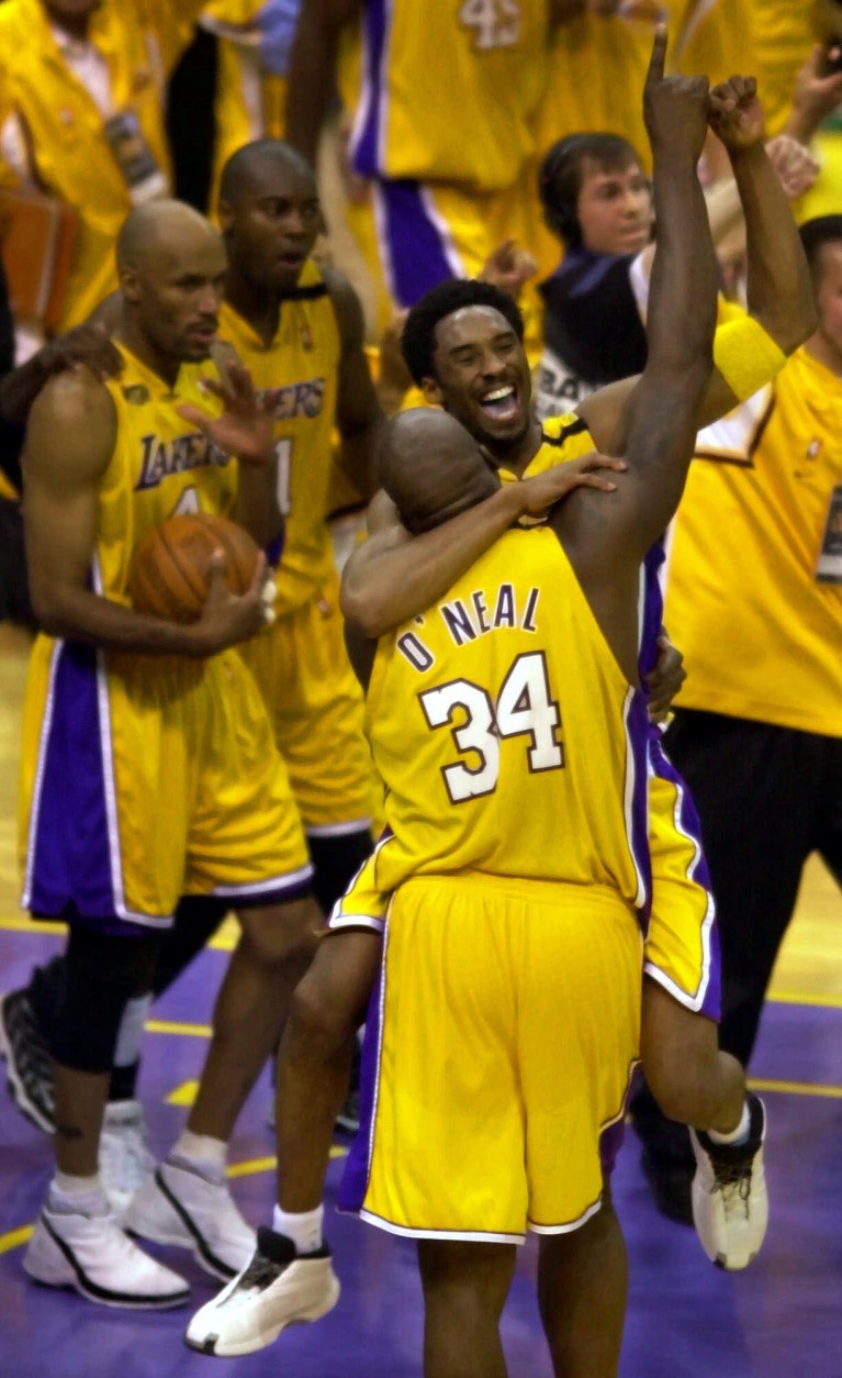 Los Angeles Lakers' Kobe Bryant and Shaquille O'Neal hug and lift their arms in victory after taking the NBA Championship in six games with a 116-111 win over the Indiana Pacers in Los Angeles Monday, June 19, 2000. (AP Photo/Michael Caulfield)