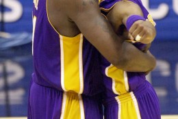 FILE-This May 21, 2001 file photo shows Los Angeles Lakers center Shaquille O'Neal, left, and teammate Kobe Bryant embracing at mid court during the final second of their victory over the  San Antonio Spurs in game two of the Western Conference Finals in San Antonio, Texas, Monday, May 21, 2001. O'Neal says Wednesday June 1, 2011, on Twitter that he's "about to retire." O'Neal sent a Tweet shortly before 2:45 p.m. saying, "im retiring." It included a link to a 16-second video in which he says, "We did it; 19 years, baby. Thank you very much. That's why I'm telling you first: I'm about to retire. Love you. Talk to you soon." (AP Photo/Eric Gay,File)